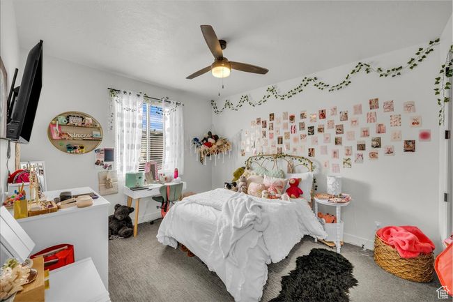 Bedroom featuring a ceiling fan, carpet floors, and baseboards | Image 15