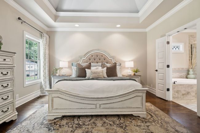 Harwood Floors, Vaulted trey ceiling with designer paint color, additional crown mold detail and recessed lighting. French doors lead into the bath with private closet/dressing room. | Image 24