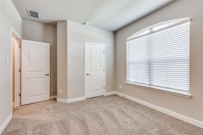 Unfurnished bedroom featuring light colored carpet and multiple windows | Image 12