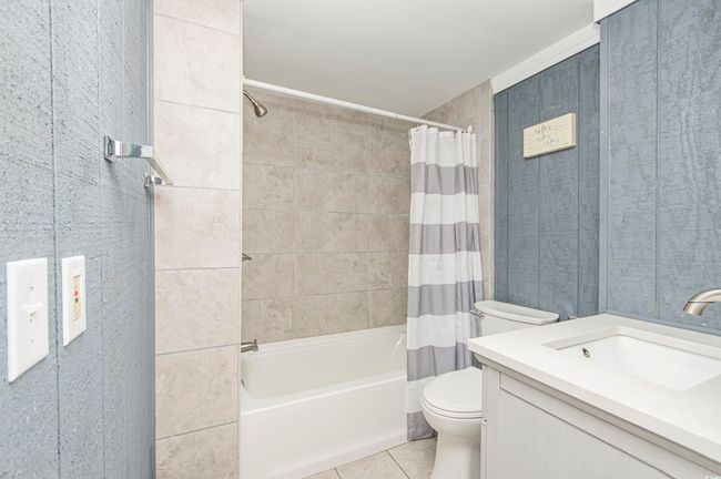 Bathroom featuring tile patterned flooring, shower / tub combo, and vanity | Image 21