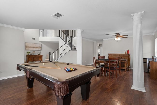 The second living area/gameroom offers high ceilings, beautiful white pillars, and an open flow into the formal dining room | Image 19