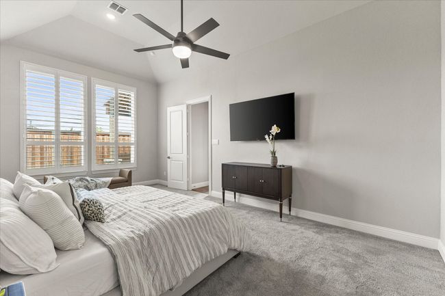 Bedroom with lofted ceiling, carpet, plantation shutters and a ceiling fan | Image 22