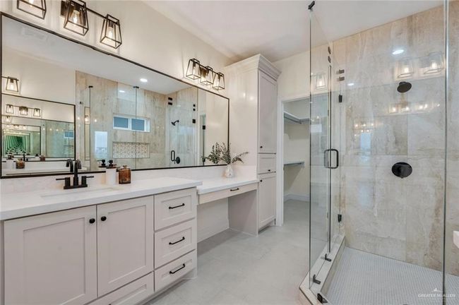 Bathroom with a stall shower, vanity, and a closet | Image 14