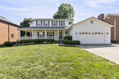 Gracious Farmhouse style executive home with inviting wrap around porch. | Image 1