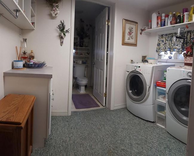 Laundry area with washer and clothes dryer and carpet flooring | Image 28