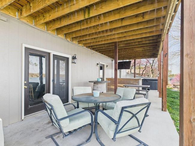 View of lower patio with outdoor dining area | Image 16