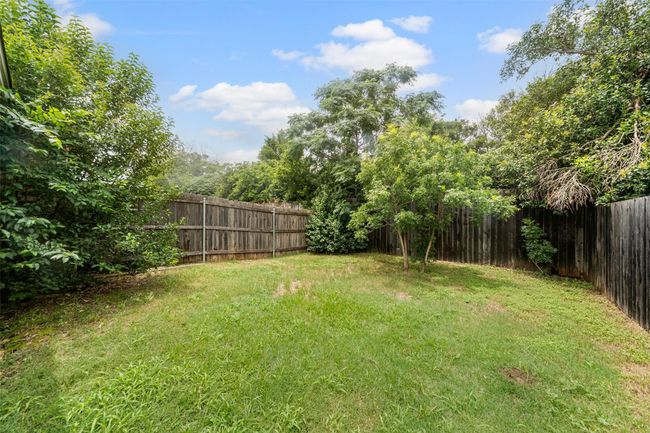 View of fenced backyard | Image 15