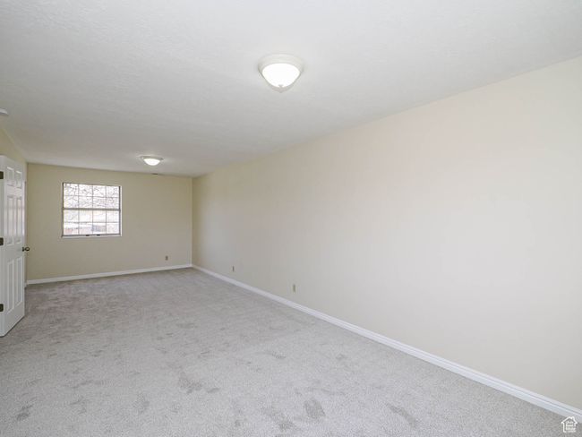 Spare room featuring baseboards and light carpet | Image 41
