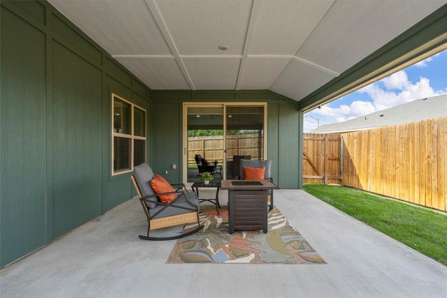 View of patio / terrace with a fire pit and fence | Image 23