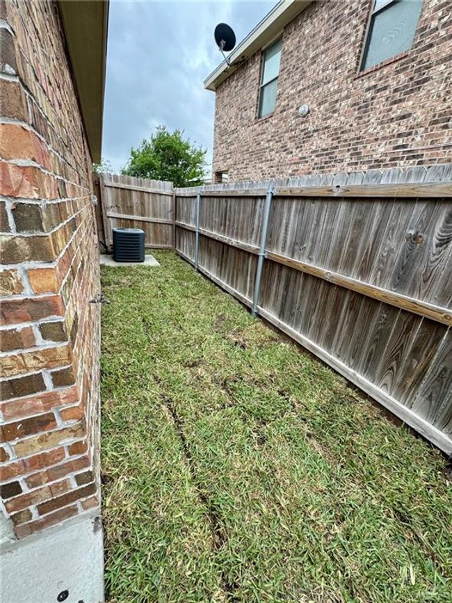 View of yard with a fenced backyard and central AC unit | Image 12
