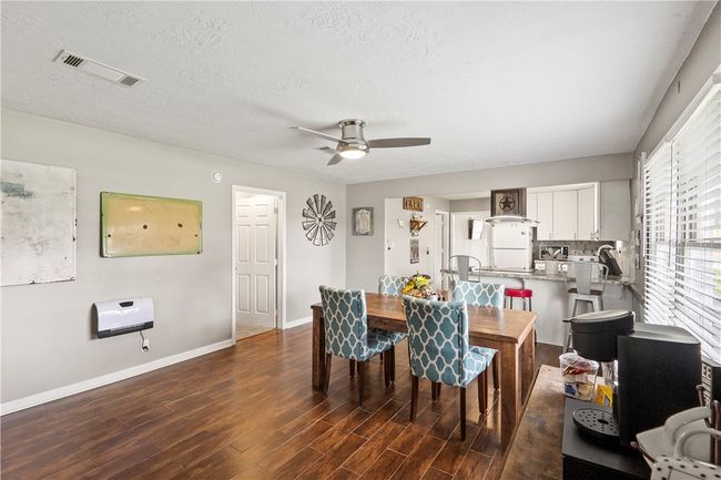 Dining space with wood finished floors, a ceiling fan, and a textured ceiling | Image 20