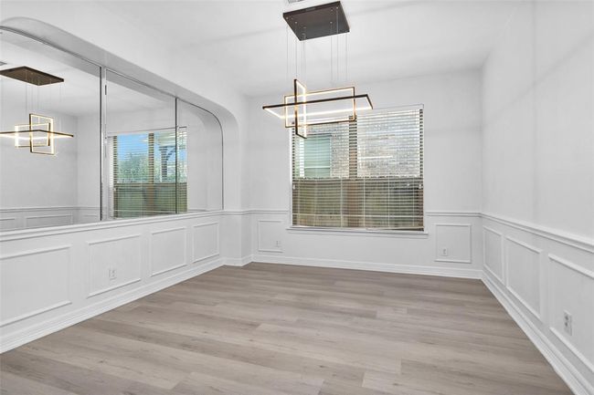 The formal dining room is light and bright with updated light fixture. | Image 8