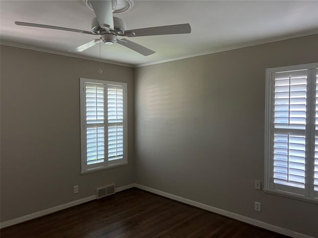 Empty room featuring ornamental molding, dark wood-type flooring, and ceiling fan | Image 17