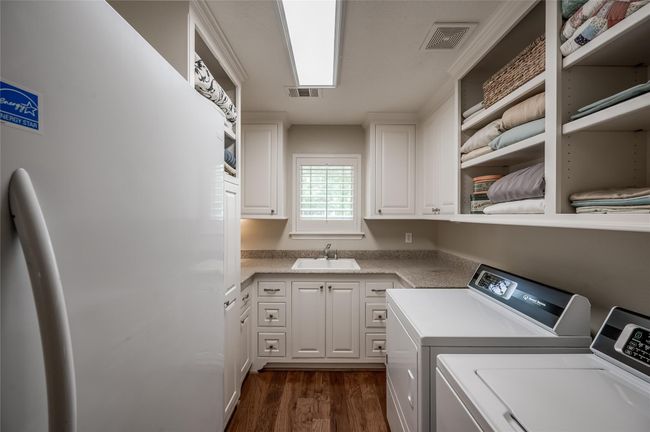 Conveniently located by the garage entry, this laundry room features offers both electric and gas dryer connections. | Image 22