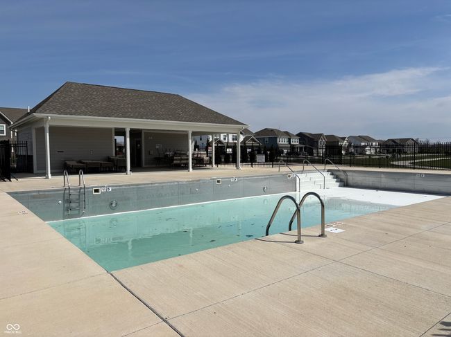 community pool with a patio area and a residential view | Image 49