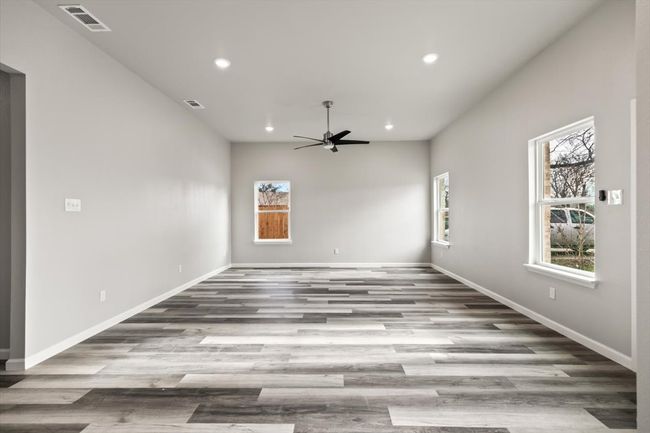 Family room featuring ceiling fan and light wood-type flooring | Image 5