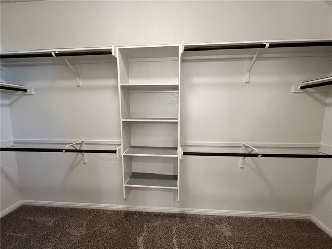 Spacious closet with dark carpet | Image 35