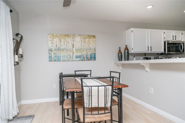 Dining room featuring ceiling fan, light wood-type flooring, recessed lighting, and baseboards | Image 9