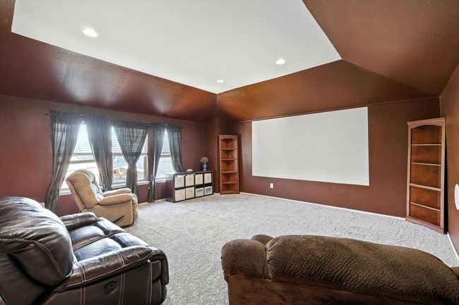 Cinema room with vaulted ceiling, carpet flooring, and recessed lighting | Image 16