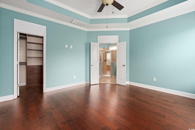 Unfurnished bedroom featuring ornamental molding, visible vents, and dark wood finished floors | Image 17