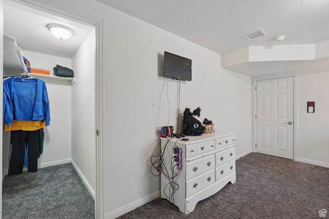 Interior space with dark colored carpet and visible vents | Image 43