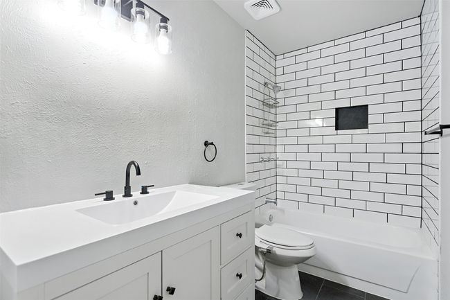 Full bathroom featuring vanity, tub / shower combination, and tile patterned flooring | Image 19