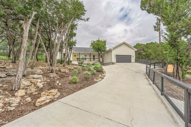 Ranch-style house featuring an inviting porch, concrete driveway, and an attached oversized 2 car garage. | Image 30