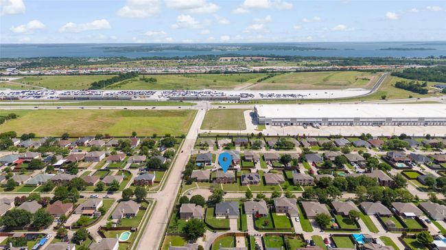 Aerial overview of property's location with a nearby body of water and nearby suburban area | Image 34