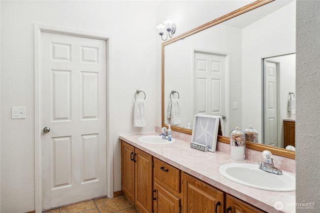 Large counter space with double sinks.Door to the shower and toilet | Image 16
