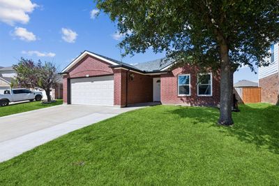 Single story home featuring a garage and a front lawn. Grass has been digitally enhanced. | Image 3