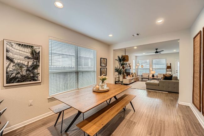 Dining area with visible vents, baseboards, a ceiling fan, and wood finished floors | Image 10