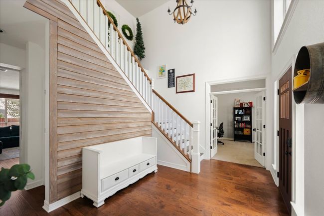 Love the wood floors at the entry -and the decorative wall. Sets the stage for the farmhouse feel of this home. | Image 15
