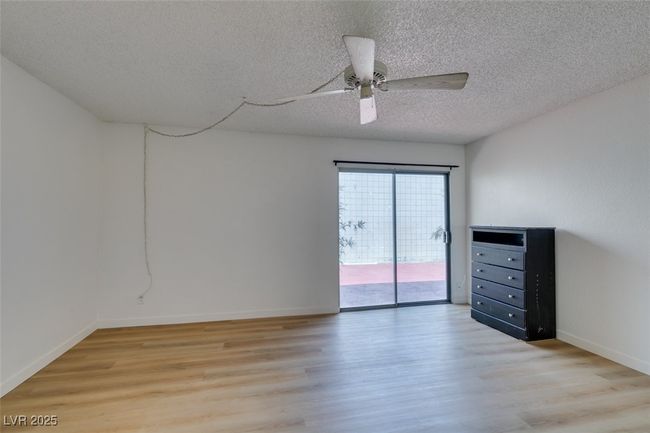 Unfurnished room with light wood-style flooring, a textured ceiling, and a ceiling fan | Image 31