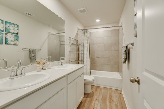 Bathroom featuring a large vanity and tub shower combo | Image 23