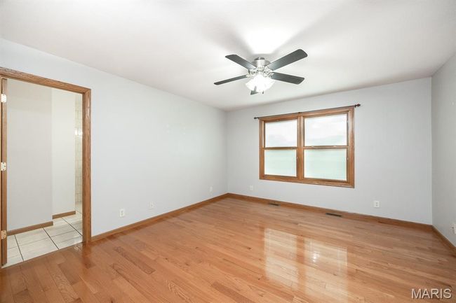 Spare room featuring ceiling fan, light wood-style floors, and baseboards | Image 21