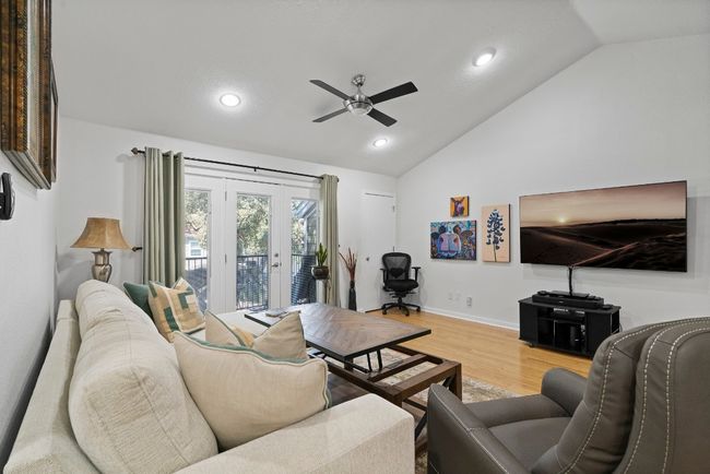 Living area with lofted ceiling, ceiling fan, light wood-style flooring, recessed lighting, and baseboards | Image 9