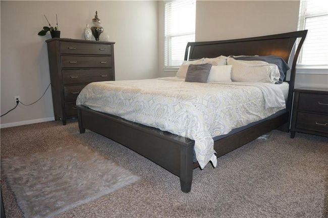 Bedroom featuring carpet floors and baseboards | Image 8