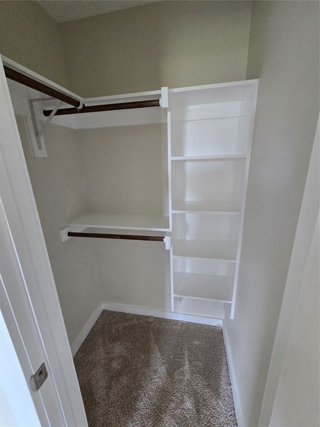 Spacious closet with carpet floors | Image 33