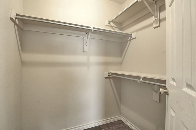 Spacious closet with dark hardwood / wood-style floors | Image 17