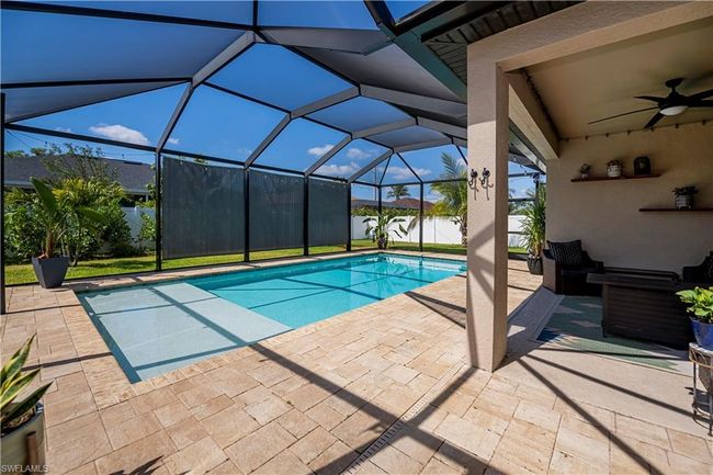 View of pool featuring a fenced in pool, a ceiling fan, a patio area, and a water view | Image 21