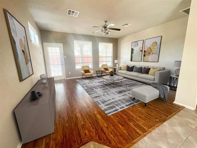 Living area featuring baseboards, a ceiling fan, and light wood-style floors | Image 4