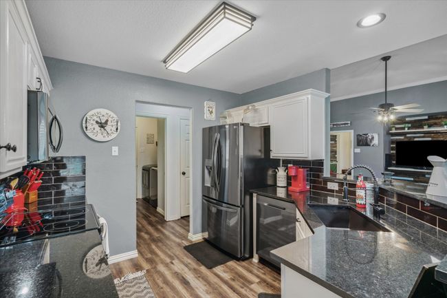 Black granite countertops and black tile backsplash | Image 14