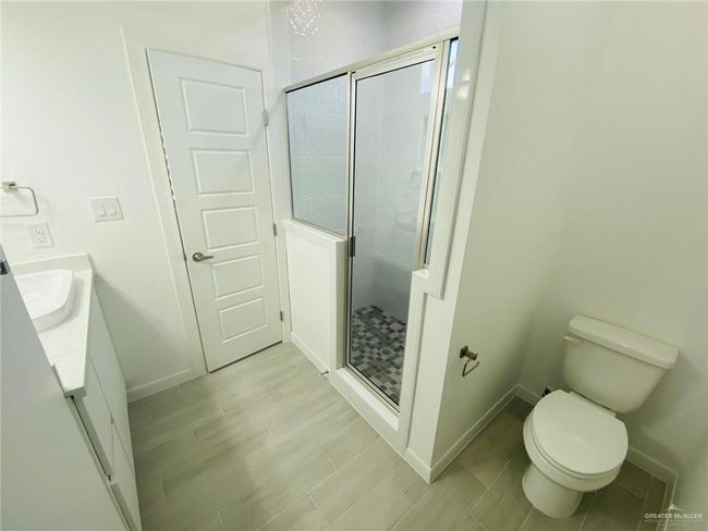 Bathroom with a shower stall and vanity | Image 10