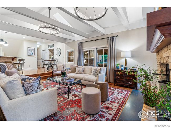 French Doors open to Covered Patio, Outdoor Dining, and Fenced Backyard. | Image 16