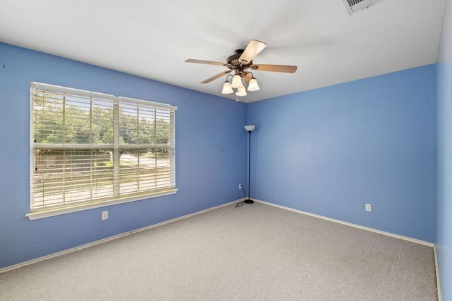 Carpeted spare room featuring a ceiling fan and baseboards | Image 20