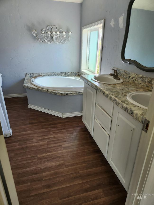 Bathroom featuring a garden tub, wood finished floors, and double vanity | Image 5
