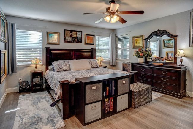 Bedroom featuring light wood-type flooring and ceiling fan | Image 16