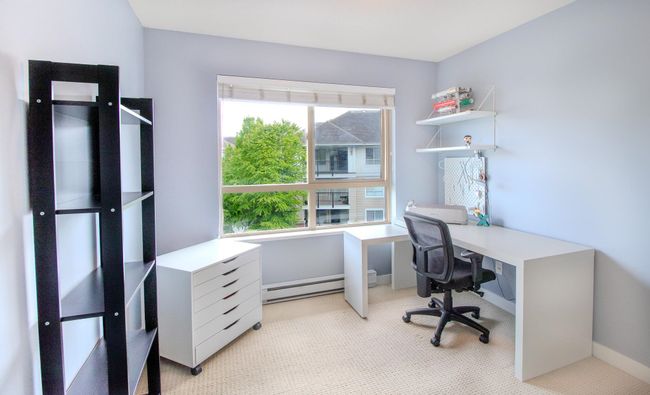 Home office with light colored carpet and a baseboard radiator | Image 9