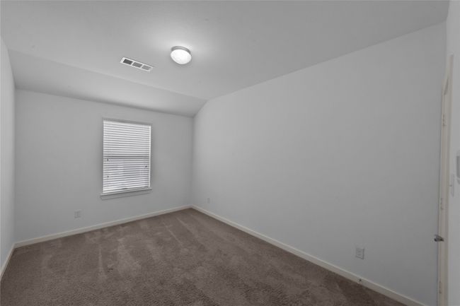 Unfurnished room with carpet flooring and lofted ceiling | Image 31