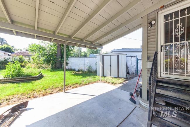 Fenced backyard featuring a patio, a storage unit, and entry steps | Image 16